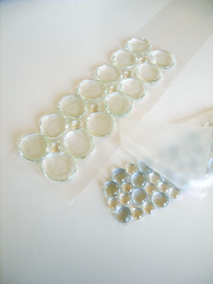 Glass globs (also called glass flats, nuggets, pebbles, gems, or half-marbles) are most often used to fill the bottom of a vase. They’re available in a dazzling array of colors and finishes from frosty tumbled textures to pearly iridescent. Find them at craft stores, florist shops, or online at MegaGlass.com.